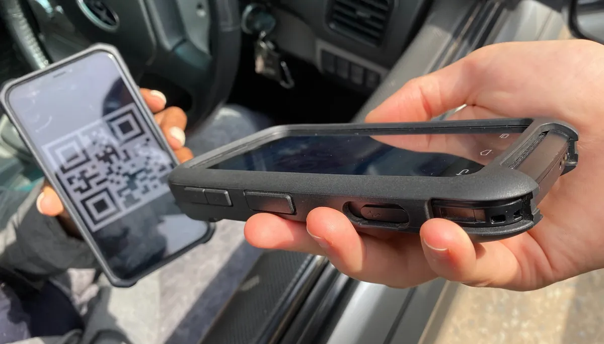 A checkpoint QR code being scanned on a phone during a patrol