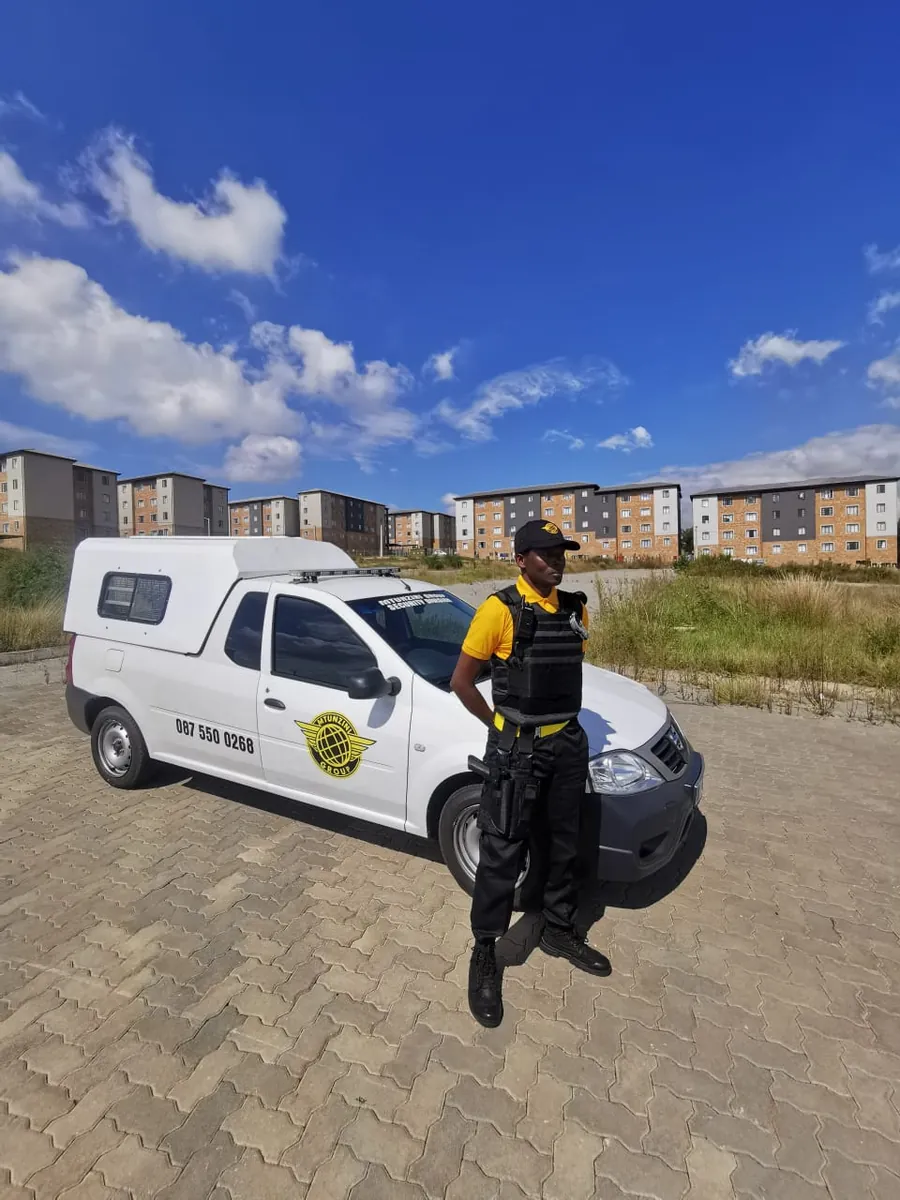 Mtunzini Group officer with a branded patrol vehicle in a residential area